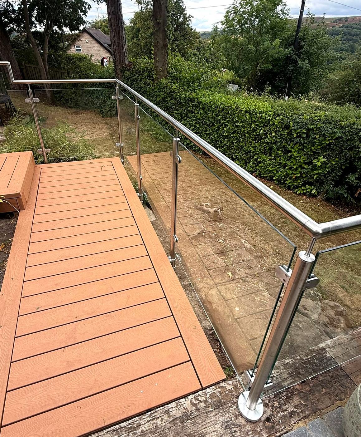 Satin stainless steel balustrade posts and glass clamps at a corner, Sheffield S17